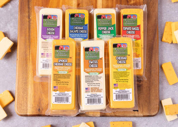 Wisconsin Cheese Company – 100% Wisconsin Specialty Cheese Block Sampler Holiday Gift Pack (7 Blocks) – Cheddar, Pepper Jack, Swiss, Gouda, Salami, Smoked Cheddar & Tomato Basil | Perfect For Parties, Charcuterie Boards, And Holiday Gifts